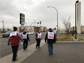 Members of United Food and Commercial Workers Local 1400, including union president Norm Neault, walk a picket line outside a Sasaktoon Co-op gas bar in Saskatoon's Blairmore neighbourhood. The union began striking on Thursday, Nov. 1, 2018. Saskatoon StarPhoenix photo by Alex MacPherson.