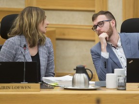 Coun. Mairin Loewen (L) speaks to Coun. Zach Jeffries during the budget deliberations at city hall in Saskatoon,Sk on Monday, November 26, 2018.