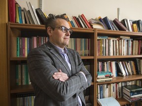 University of Saskatchewan professor Charles Smith sits for a photograph in his office at Saint Thomas More in Saskatoon on Dec. 4, 2018.