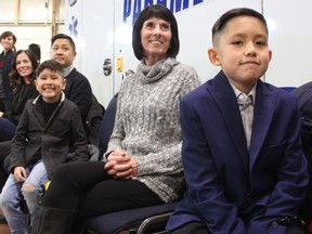 Patti Chatterson, centre, sits with her 10-year-old grandson, Kian Wu (right), and seven-year-old grandson Grayson Wu, as the family listened to audio of a 911 call at a award ceremony on Dec. 4, 2018. Kian and Grayson were both given Star Awards after the two called 911 and performed CPR on Chatterson after she went into cardiac arrest on Nov. 10, 2018.