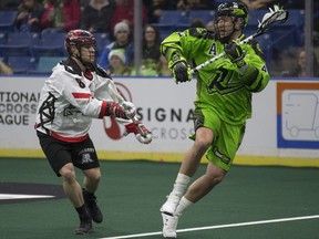 Calgary Roughnecks forward Adam Dickson goes to defend against Saskatchewan Rush forward Mark Matthews during the game at SaskTel centre in Saskatoon,Sk on Saturday, December 8, 2018.