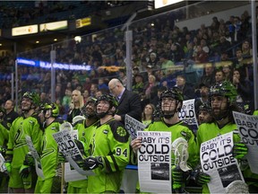 Saskatchewan Rush players hold up signs that showcase the song "Baby It's Cold Outside" during the game at SaskTel centre in Saskatoon, Sask. on Saturday, Dec. 8 2018.