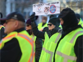 Monique Quintal protests outside City Hall on Saturday, Dec. 8, 2018, as part of a group of "yellow vest" protesters rallying against the carbon tax and the federal government's decision to sign on to the UN's global migration compact.
