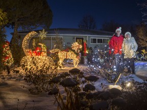 Janet and Ken Wanner stand for a photograph with their large holiday light display in their yard in Saskatoon, SK on Wednesday, December 12, 2018.