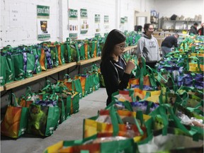 Young volunteer Kaitlyn Cho sets out food hampers at the Saskatoon Food Bank and Learning Centre on Dec. 15, 2018 during the Christmas Hamper Day.