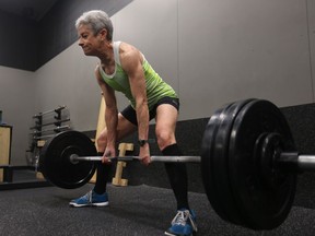 Janet Hills lifts weights in the Mackie Physiotherapy gym on Dec. 13, 2018. She holds a number of women's power-lifting records.