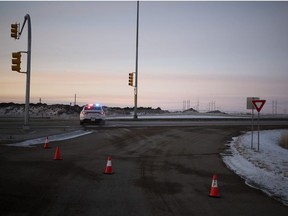 A police vehicle is parked on the road on Valley Road and the Landfill Access Road in Saskatoon on Sunday, Dec. 23, 2018.