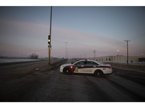 A police vehicle is parked on the road on Valley Road and the landfill access road in Saskatoon on Dec. 23, 2018.