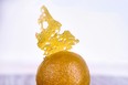 Detail of cannabis oil (aka shatter) and live resin in a ball shape isolated against white background