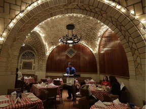 A server works beneath the tiled and vaulted ceilings at The Oyster Bar at Grand Central Terminal in New York, Wednesday, Jan. 9, 2013. When the restaurant opened it's doors in 1913, Woodrow Wilson was president, the nation was on the verge of World War 1, and prohibition was six years away.