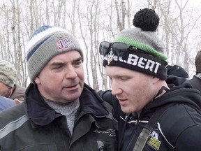 Humboldt Broncos assistant coach Chris Beaudry, right, embraces Adam Herold's father Russ as family and friends celebrate what would have been Adam's 17th birthday in Montmartre, Sask. on Thursday, April 12, 2018. The father of one of the boys killed in the Humboldt Broncos bus crash called mandatory training for commercial semi-truck drivers in the province a good first step, but one that does not go far enough.