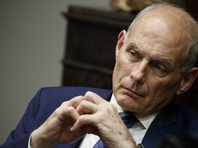 In this June 21, 2018 photo, White House chief of staff John Kelly listens as President Donald Trump speaks during a lunch with governors in the Roosevelt Room of the White House in Washington. Trump says chief of staff John Kelly will leave his job at the end of the year.