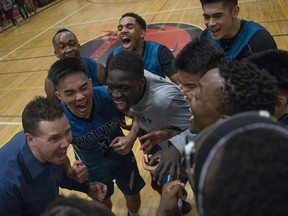 Bishop McNally Timberwolves celebrate after winning the championship game against the Harry Ainlay Titans during the BRIT championship game in Saskatoon,Sk on Saturday, January 12, 2019.