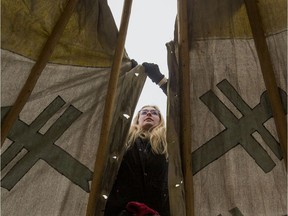 Katie Willie, an archeology interpretive guide at Wanuskewin, helps put up a teepee near Victoria School to host storytelling during the Winterruption festival in Saskatoon, Wednesday, January 22, 2019.