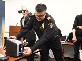 Saskatoon Police Service Staff Sergeant Patrick Barbar demonstrates how to use the new Draegar DrugTest 5000 device at the police station in Saskatoon on Jan. 24, 2018.