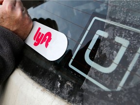 Ride-sharing giants Uber and Lyft, whose stickers are seen on a vehicle in Pittsburgh, Pa. in this January 2018 photo, have yet to identify a date on which they plan to begin operating in Saskatoon.