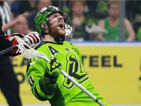 Saskatchewan Rush's Ben McIntosh reacts to a hit from Calgary Roughnecks' Chad Cummings during a one-game, sudden-death playoff game at SaskTel Centre in Saskatoon, Sask. on May 13, 2018.