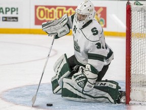 SASKATOON,SK--OCTOBER 12/2018-1013 Sports Huskies Hockey - University of Saskatchewan Huskies goalie Taran Kozun secures the puck against the University of Calgary Dinos during first period U Sport Hockey action at Merlis Belsher Place in Saskatoon, SK on Friday, October 12, 2018.