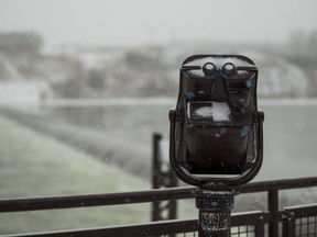 Snow collects on the binoculars looking over the weir in Saskatoon, SK on Monday, January 7, 2018.
