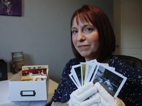 Angela Turner, a professional organizer and the owner of Saskatoon Organizing Systems, with a handful of photos in her home office on Jan. 15, 2019. The aim of her business is to help people sort their overwhelming photo collections, allowing them to preserve their memories and their sanity.