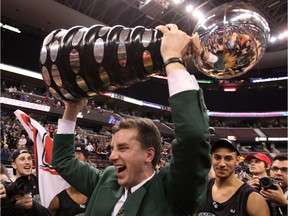Head coach Greg Jockims raises the trophy over his head in celebration as the University of Saskatchewan Huskies celebrate their victory over the University of British Columbia Thunderbirds by a score of 91-81 in the championship final of the Canadian Interuniversity Sports Final 8 men's basketball championship held at Scotiabank Place in Ottawa, March 21, 2010.