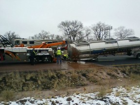 This Monday, Jan. 14, 2019 photo provided by the Arizona Department of Public Safety shows the scene of a crash about 11 miles east of Flagstaff, Ariz.  A tank trucker's trailer detached from the truck and rolled on its side on slick pavement, spilling a river of liquid chocolate onto westbound lanes of Interstate 40. Department of Public Safety spokesman Bart Graves said the wreck required cleanup crews to pour most of the 40,000 gallons (151,412 liters) of chocolate into the highway median to lighten the damaged tanker so it could be towed away. The DPS said there were no injuries and the driver was not cited.