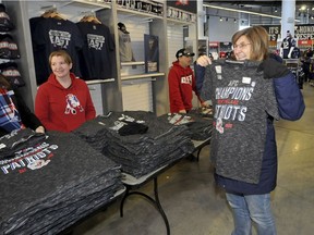 New England Patriots fan Lisa Nieforth, right, of Lincoln, R.I., holds up an AFC Championship T-shirt she purchased at the New England Patriots Pro Shop at Gillette Stadium in Foxboro, Mass., Monday, Jan. 21, 2019. The Patriots defeated the Kansas City Chiefs the night before earning them a spot in Super Bowl LIII.