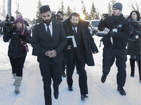 Jaskirat Singh Sidhu leaves provincial court with his lawyer Mark Brayford (centre right) in Melfort, Sask., Tuesday, January, 8, 2019. Sidhu, the driver of a transport truck involved in a deadly crash with the Humboldt Broncos junior hockey team's bus, has pleaded guilty to all charges against him.