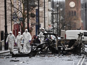 Forensic officers inspect the remains of the van used as a car bomb on an attack outside Derry Court House on January 20, 2019 in Londonderry, Northern Ireland. (Charles McQuillan/Getty Images)
