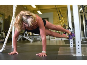 Helen Vanderburg demonstrates TRX moves at Heavens Fitness in Calgary, Alta., on Thursday, July 7, 2016. Elizabeth Cameron/Postmedia