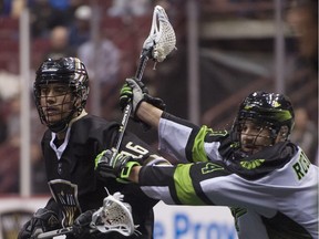 Saskatchewan Rush defender Kyle Rubisch pushes out Vancouver Warriors player Mitch Jones during a regular-season NLL lacrosse game at Rogers Arena, Vancouver, on Jan. 12, 2019. Gerry Kahrmann / PNG staff photo)