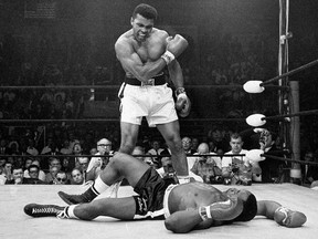 In this May 25, 1965, file photo, heavyweight champion Muhammad Ali stands over fallen challenger Sonny Liston shortly after dropping him in Lewiston, Maine. (AP Photo/John Rooney, File)