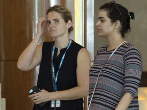 Rahaf Mohammed Alqunun, right, walks with an unidentified companion in Bangkok, Thailand, Friday, Jan. 11, 2019.