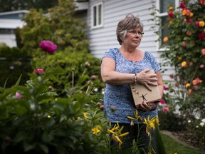 Wendy Gould holds the cremated remains of her late husband George Gould at her home, in Aldergrove, B.C., on Friday May 25, 2018. Wendy and George Gould were supposed to grow old together. But Wendy says their future was ripped away from them when George contracted a drug-resistant infection in a Vancouver hospital. During the final 18 months of his life, she says George was admitted to hospital 22 times for intravenous antibiotics that triggered violent nausea and frightening hallucinations. In January, he died in an isolation unit at age 58.