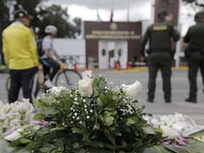 An impromptu memorial sits outside the General Francisco de Paula Santander Police Academy, a day after a car bomb exploded at the site, in Bogota, Colombia, Friday, Jan. 18, 2019. Colombia blames the National Liberation Army, ELN, rebels for the deadly attack that left more than 20 dead and wounded many others.