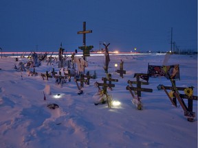 Light trails from a vehicle are seen in a long exposure of the memorial for the Humboldt Broncos bus crash at the intersection of highways 35 and 335 inside the the Rural Municipality of Connaught, SK on Thursday, January 31, 2019.