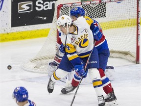 Saskatoon Blades forward Chase Wouters tries to deflect the puck under pressure from the Edmonton Oil Kings defence in Saskatoon on Saturday, February 2, 2019.