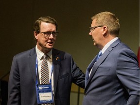 Regina Mayor Michael Fougere (left) speaks with Saskatchewan Premier Scott Moe at the SUMA convention in Saskatoon to announce a new revenue sharing formula on Monday, February 4, 2019.