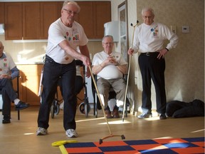 Barry Fields takes a shot during the floor shuffleboard tournament taking place as part of the The All Seniors Care Seniors Games at the Preston Park II retirement residence in Saskatoon on Feb. 7, 2019.