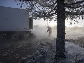 City of Saskatoon workers attend to a water main break that flooded Mckercher Drive near the intersection 8th Street East in Saskatoon, SK on Friday, February 8, 2019.