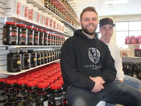 Josh MacGowan, left, the owner of Supplement World, poses for a photo with store manager Colby Stern, at the store's new location in Blairmore on Feb. 4, 2019. MacGowan said he hopes to help his customer achieve their goals while informing them about the supplements and health products they need.