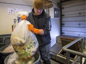 Nathan Grimard, University of Saskatchewan groundskeeper who oversees daily dehydrator operations, puts food waste into a dehydrator at Marquis hall on the U of S campus in Saskatoon, Sask. on Tuesday, Feb. 19, 2019. The University of Saskatchewan has been diverting more than 650 pounds of waste from the landfill daily thanks to a new program where they dehydrate food waste and use it elsewhere on campus.