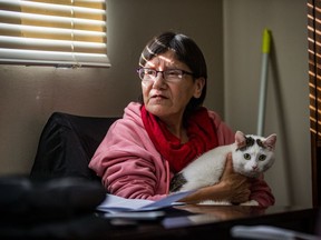 Mary-Ann McLeod and her cat, Thunder, in the west side apartment she shares with her son Jonathan.