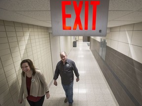 SASKATOON,SK--FEBRUARY 26/2019-0227 News Cupe- CUPE National Representative Ann Iwanchuk, left, and CUPE Local 3287 president Craig Hannah walk down a hallway with a exit sign following a media event regarding negotiations with the University of Saskatchewan in classroom at the  Health Sciences Building on the U of S campus in Saskatoon, SK on Tuesday, February 26, 2019.