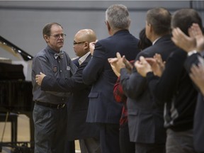 James Haughey's father, Alex (left), shakes hands with Mike San Miguel (J.P.'s uncle) during a ceremony at Bethlehem Catholic High School on Feb. 28, 2019. The Haugheys donated a baby grand piano to the school in their son's memory.