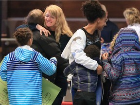 Lisa Honorat and her daughter Miesha, 12, are greeted by relieved family members after arriving back in Calgary on Sunday February 17, 2019. The two were among a group of Haiti Arise members who used a helicopter to evacuate after violent protests shook the country.