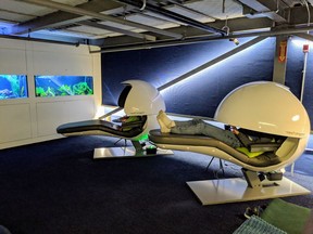 A Google Canada employee reclines on one of two nap pods at its offices in Kitchener, Ont., in this undated handout photo. Google Canada spokesman Aaron Brindle says nap rooms can be found in the tech giant's offices around the world, including the Toronto office where a wellness space for nursing mothers can be reserved for taking a break, or taking a nap. Another space at their engineering headquarters in Kitchener, Ont., features two high-tech recliners with large spherical privacy visors for extra-tired employees looking to grab some shut-eye.