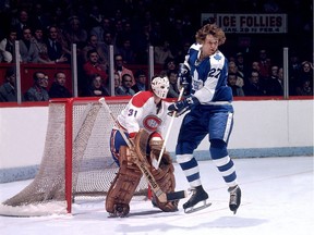 MONTREAL - 1970's:  Darryl Sittler #27 of the Toronto Maple Leafs screens goalie Michel Larocque #31 of the Montreal Canadiens.