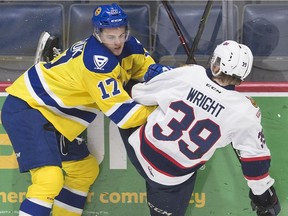 The Saskatoon Blades' Eric Florchuk, 17, gets tied up with Garrett Wright of the Regina Pats in WHL action Friday at the Brandt Centre.