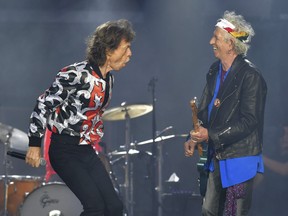 Mick Jagger (left) and Keith Richards, of The Rolling Stones, perform during their No Filter tour in London, England, on May 25, 2018. (Mark Allan/Invision/AP)